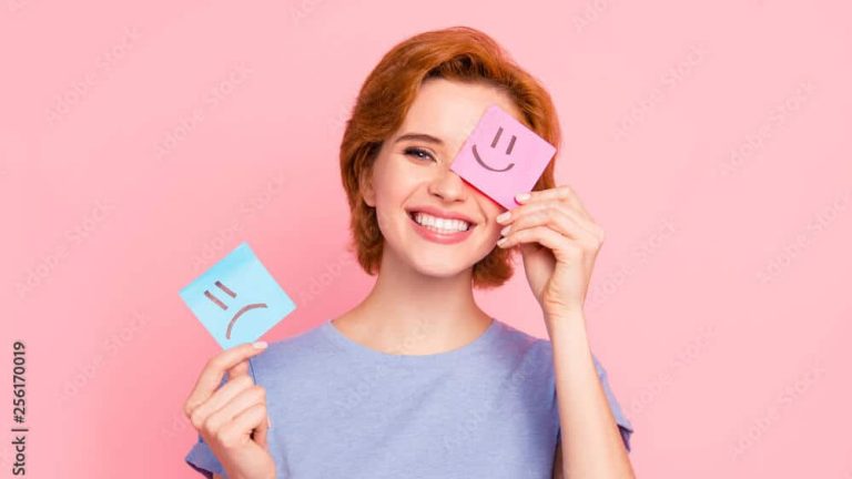 Close-up portrait of her she nice cute charming attractive cheerful girl wearing casual blue t-shirt holding in hands two draw notes positive good choice isolated on pink pastel background