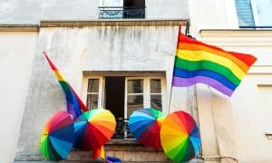 Rainbow LGBT pride flag and umbrellas decoration on a house in Marais quartier in Paris, France.