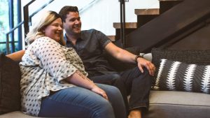 White man and woman couple watching television