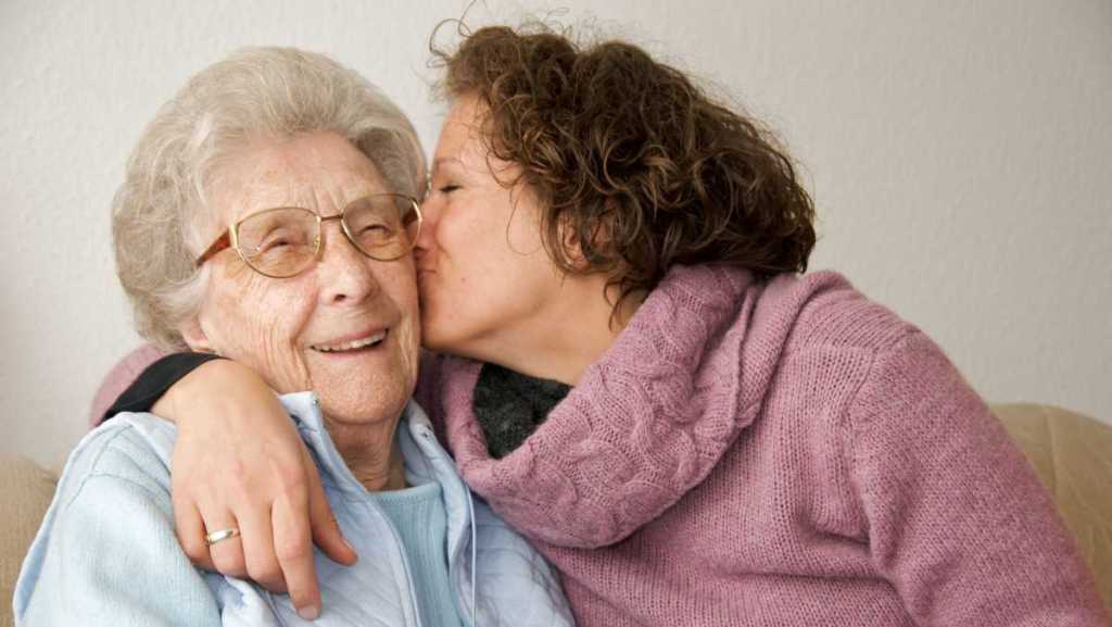 Une grand-mère et sa fille s'embrassent.