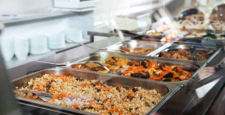 Containers with healthy food in school canteen