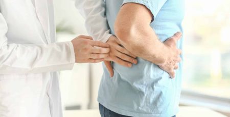 Un docteur touchant les reins d'un homme.