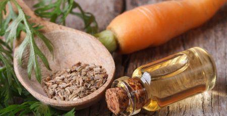 oil of carrot seeds in a glass bottle closeup top view