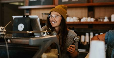 Une dame souriante travaille dans un restaurant