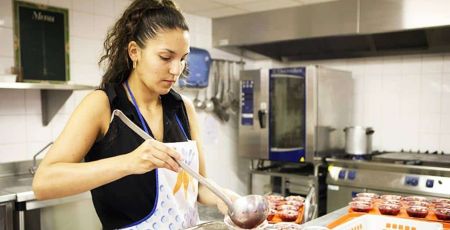 femme qui sert un plat en cuisine