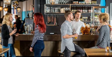 Friends Talking While Having Their Drinks In Bar
