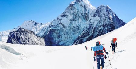 Group of climbers reaching the Everest summit in Nepal. Team work concept.