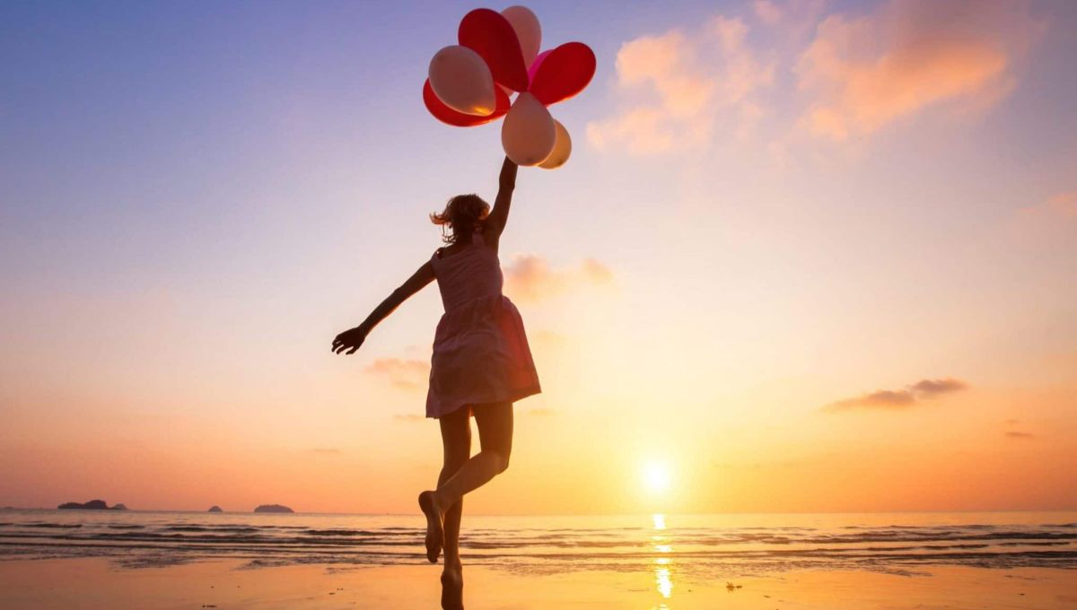 imagination, happy girl jumping with multicolored balloons at sunset on the beach, fly, follow your dream