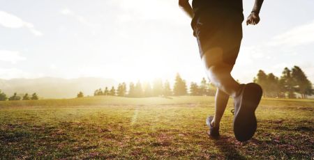 panoramic - man running marathon through the field