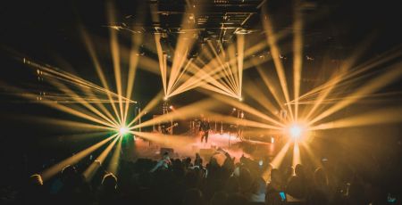 people standing on stage during night time