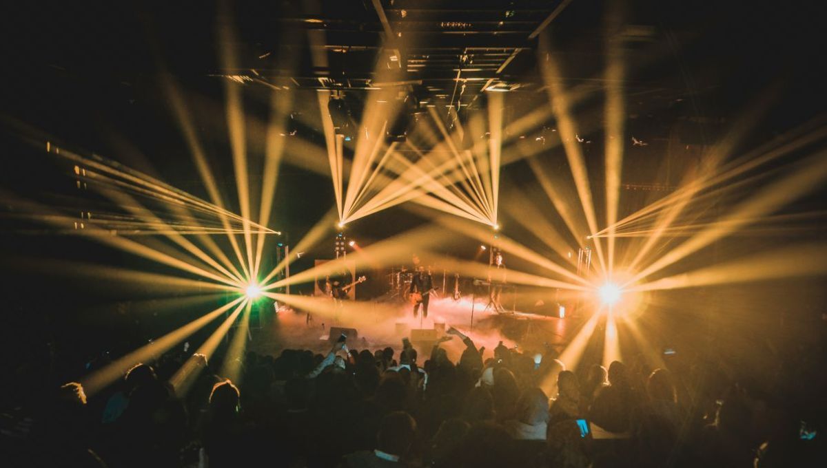 people standing on stage during night time