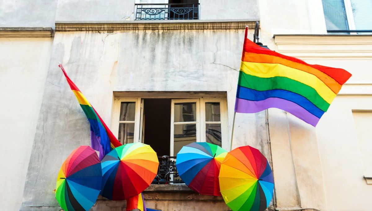 Rainbow LGBT pride flag and umbrellas decoration on a house in  Marais quartier in Paris, France.