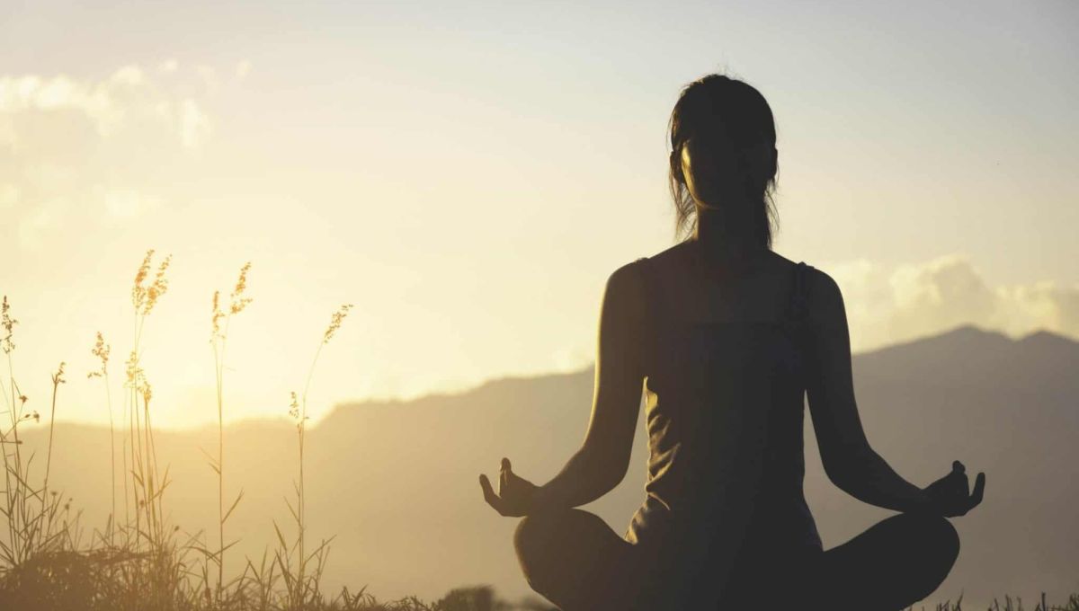 silhouette fitness girl practicing yoga on mountain