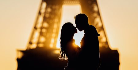 Silhouettes at sunrise in Paris, France by the Eiffel Tower