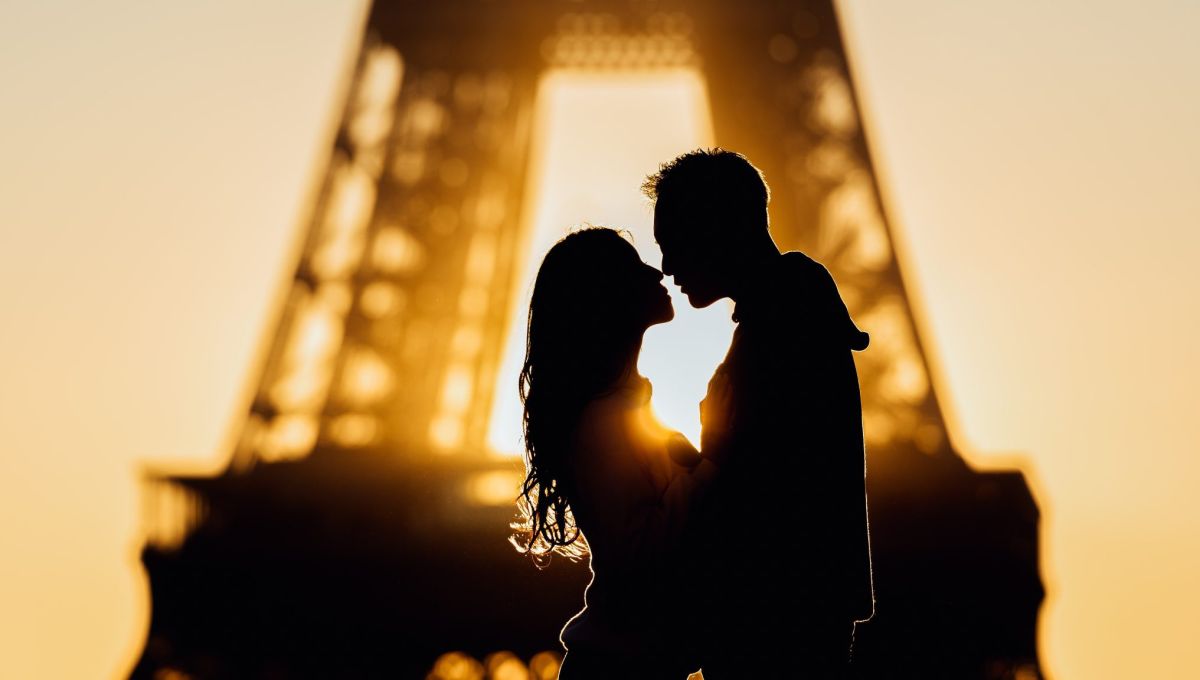 Silhouettes at sunrise in Paris, France by the Eiffel Tower