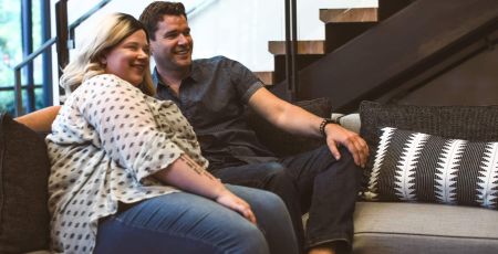 White man and woman couple watching television