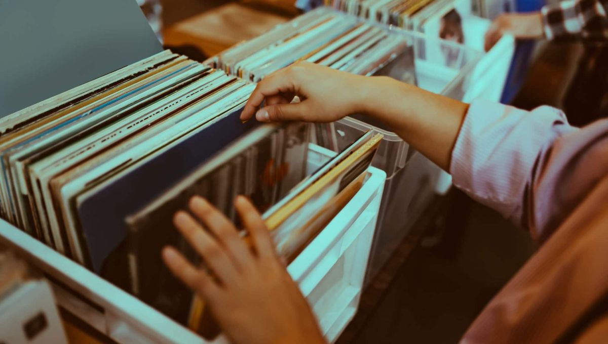 Woman is choosing a vinyl record in a musical store