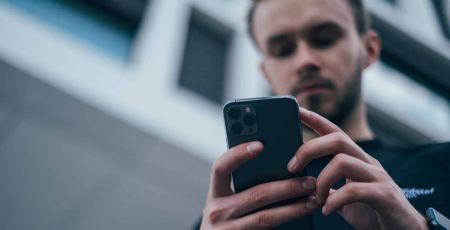 young men holding iPhone 11 Pro
